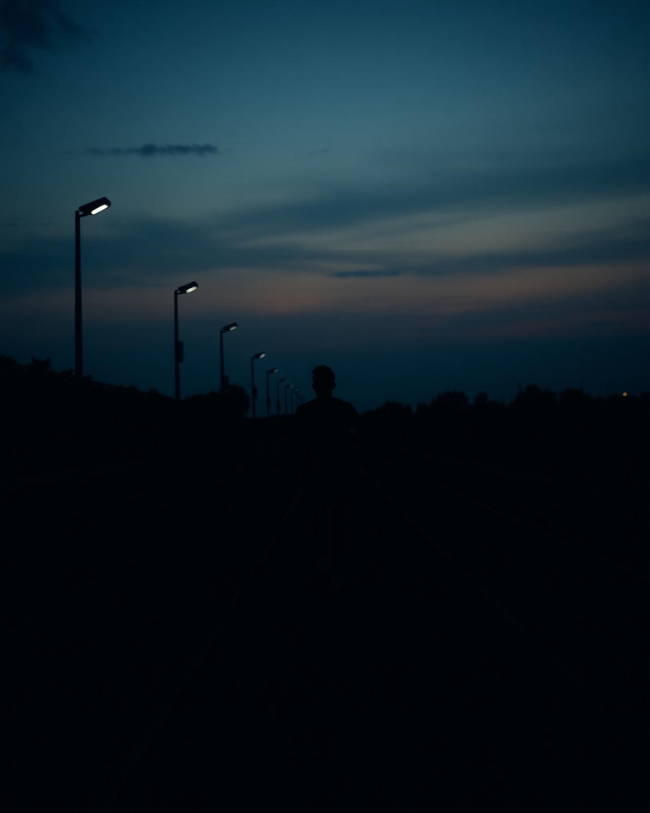 Runner at dusk on an empty track
